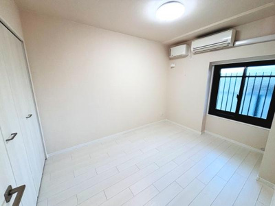 明るい色合いの床が特徴の洋室です。壁面にはクローゼットがあり収納にも便利です。エアコン付きで一年を通して快適に過ごせます。窓からは自然光が入り開放感があります。