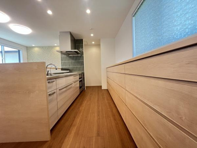 木目調のデザインが温かみを感じさせます。広々としたカウンターが特徴的です。収納スペースが充実しています。大きな窓から光が入り明るい空間です。すっきりとしたレイアウトが魅力です。