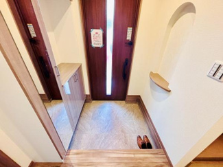 玄関には大型のミラー付収納が設置されています。明るい採光のあるドアが空間を演出しています。シューズボックスもあり片付けやすい設計です。壁面には小物を置けるニッチスペースもあります。